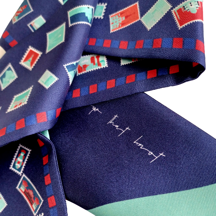 Navy & Red with Teal travel inspired stamps on a silk twill hair scarf up close