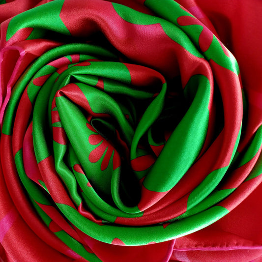 Bridget Square Silk scarf - with bright magenta pink, candy red and green floral design scrunched up close